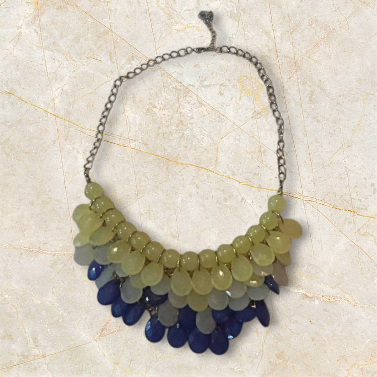 Velvet Leopard Vintage NYC statement necklace with layered teardrop beads in yellow, white, and blue on a silver chain