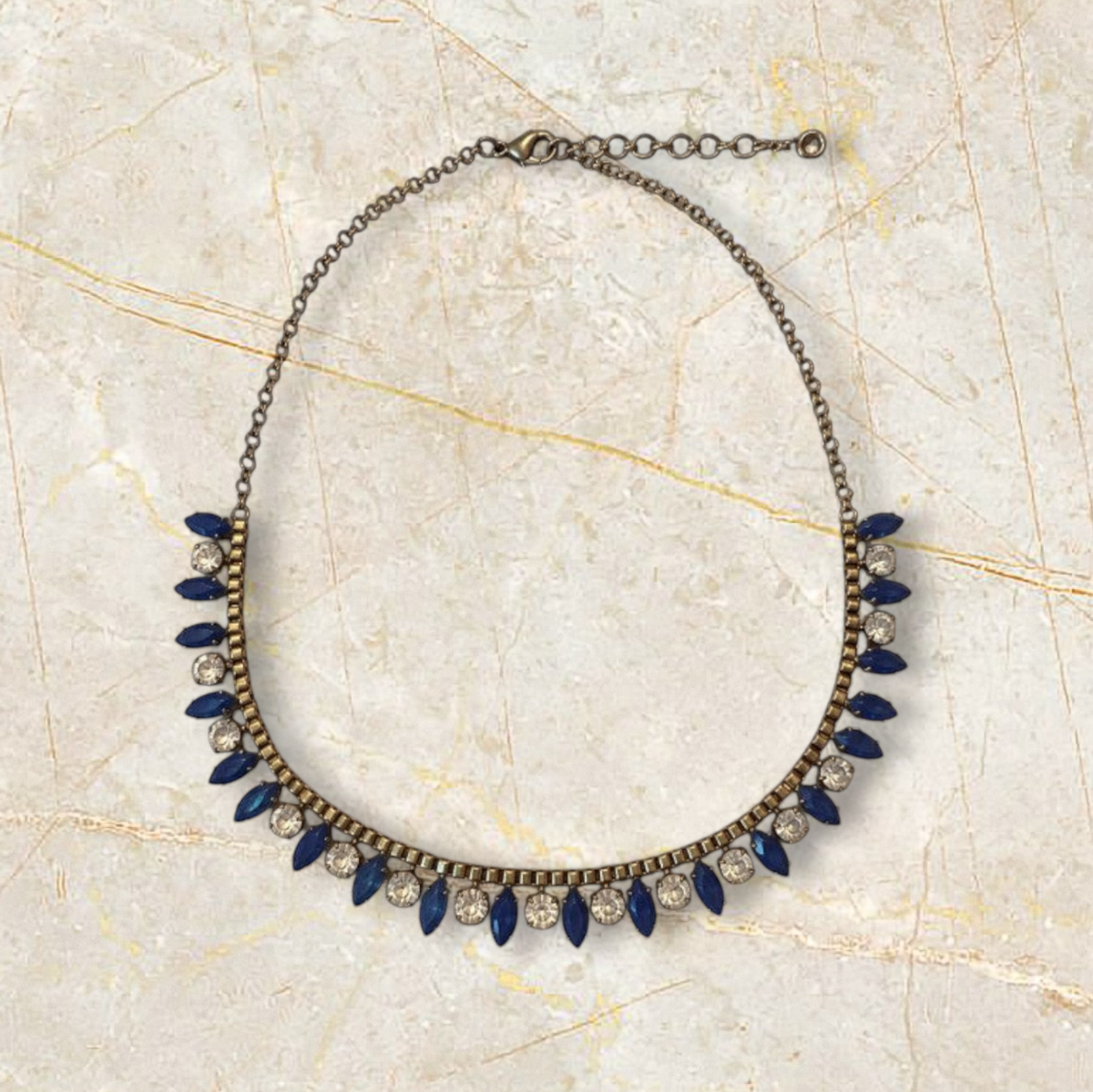 Velvet Leopard Vintage NYC statement necklace with antique gold chain, clear crystals, and royal blue marquise stones.